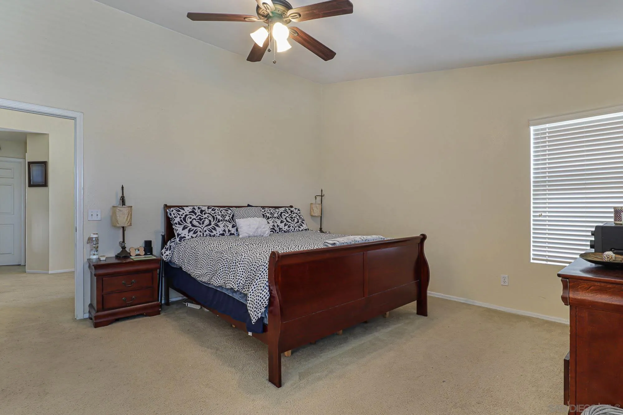 914 Rigley Street Chula Vista, CA 91911 - Photo 18 of 35 a bedroom with a bed and a chandelier