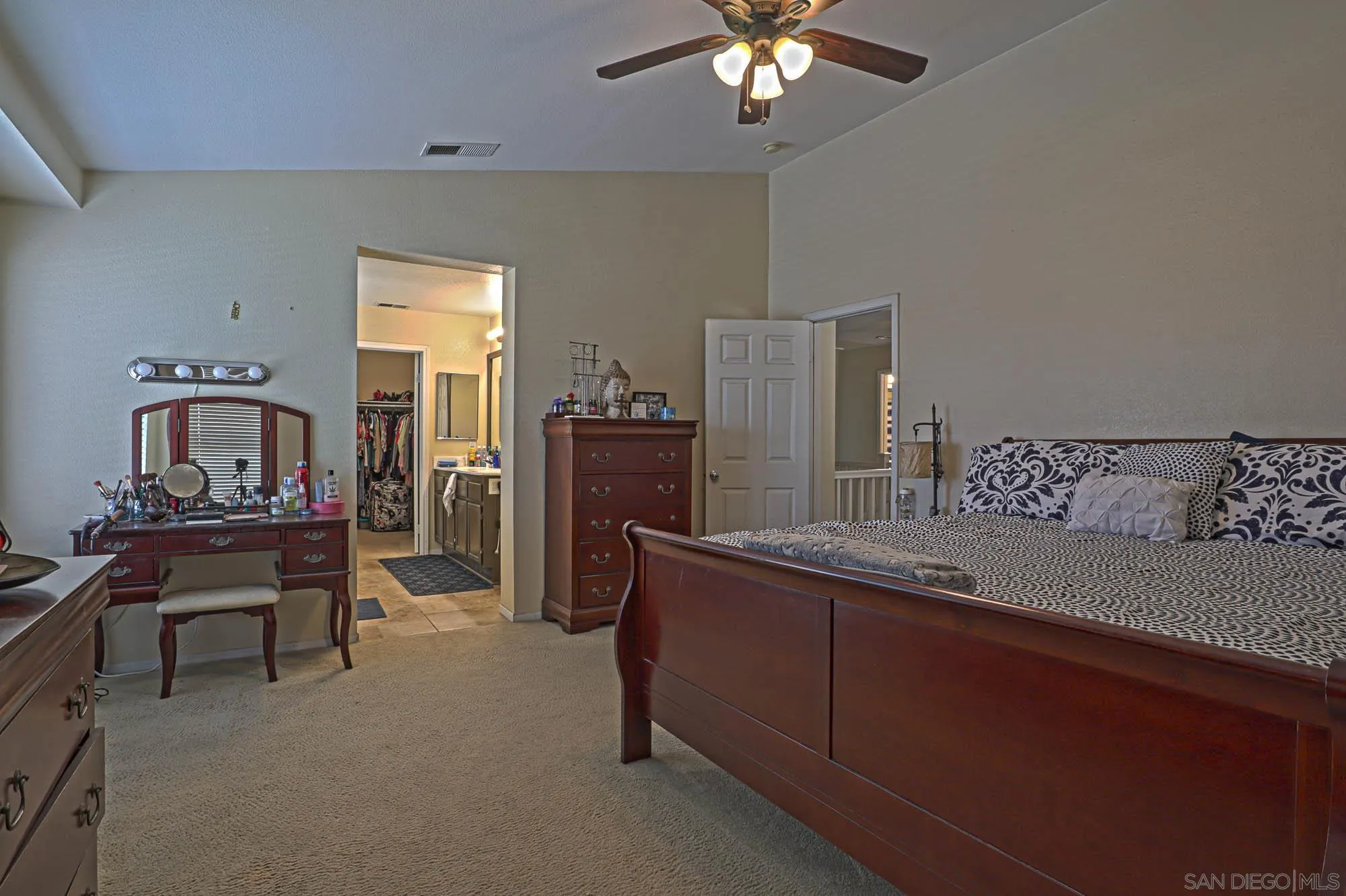 914 Rigley Street Chula Vista, CA 91911 - Photo 20 of 35 a spacious bedroom with a bed and a chandelier