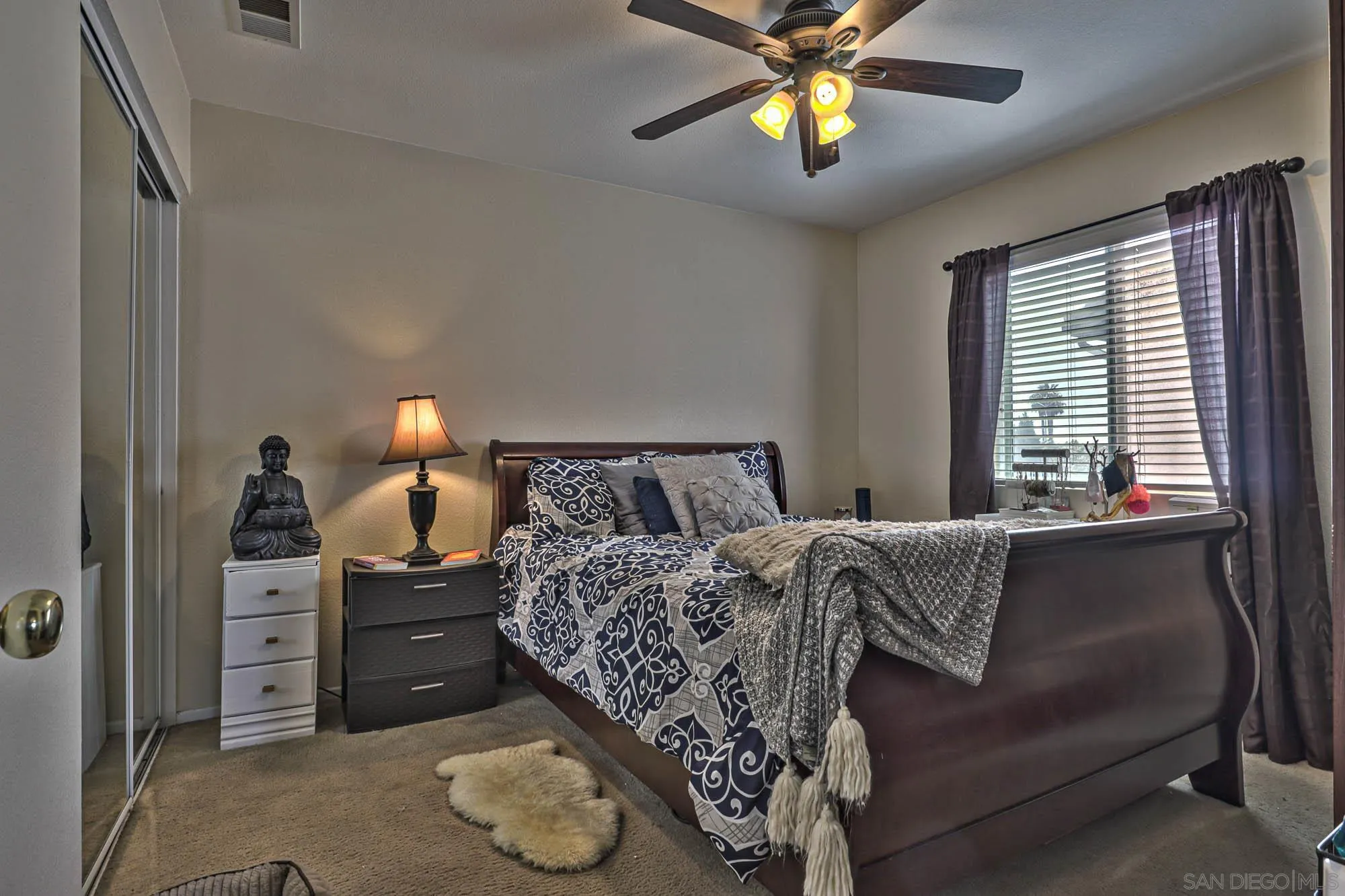 914 Rigley Street Chula Vista, CA 91911 - Photo 24 of 35 a bed room with a bed and a chandelier