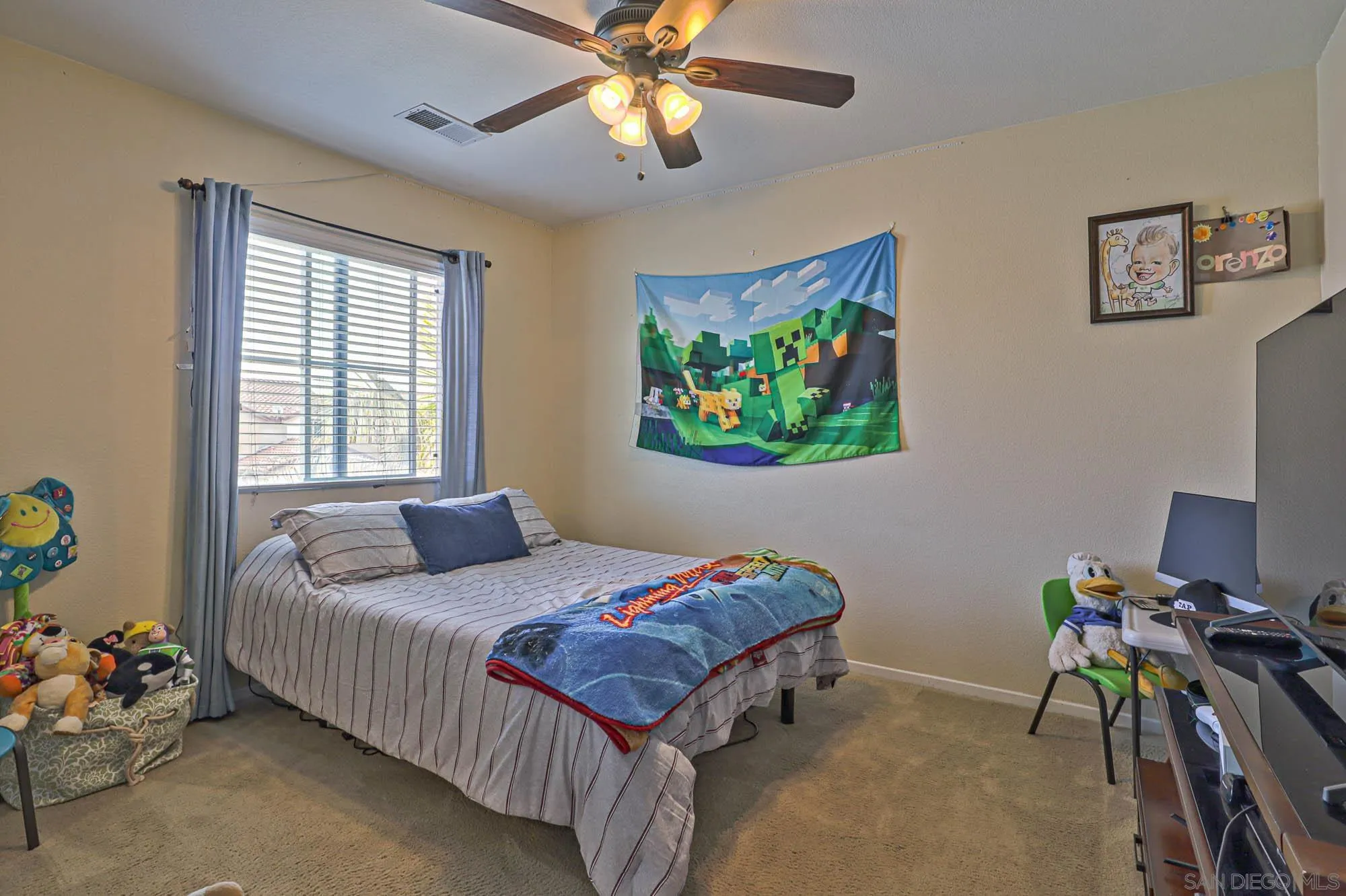 914 Rigley Street Chula Vista, CA 91911 - Photo 25 of 35 a bedroom with a bed and a chandelier