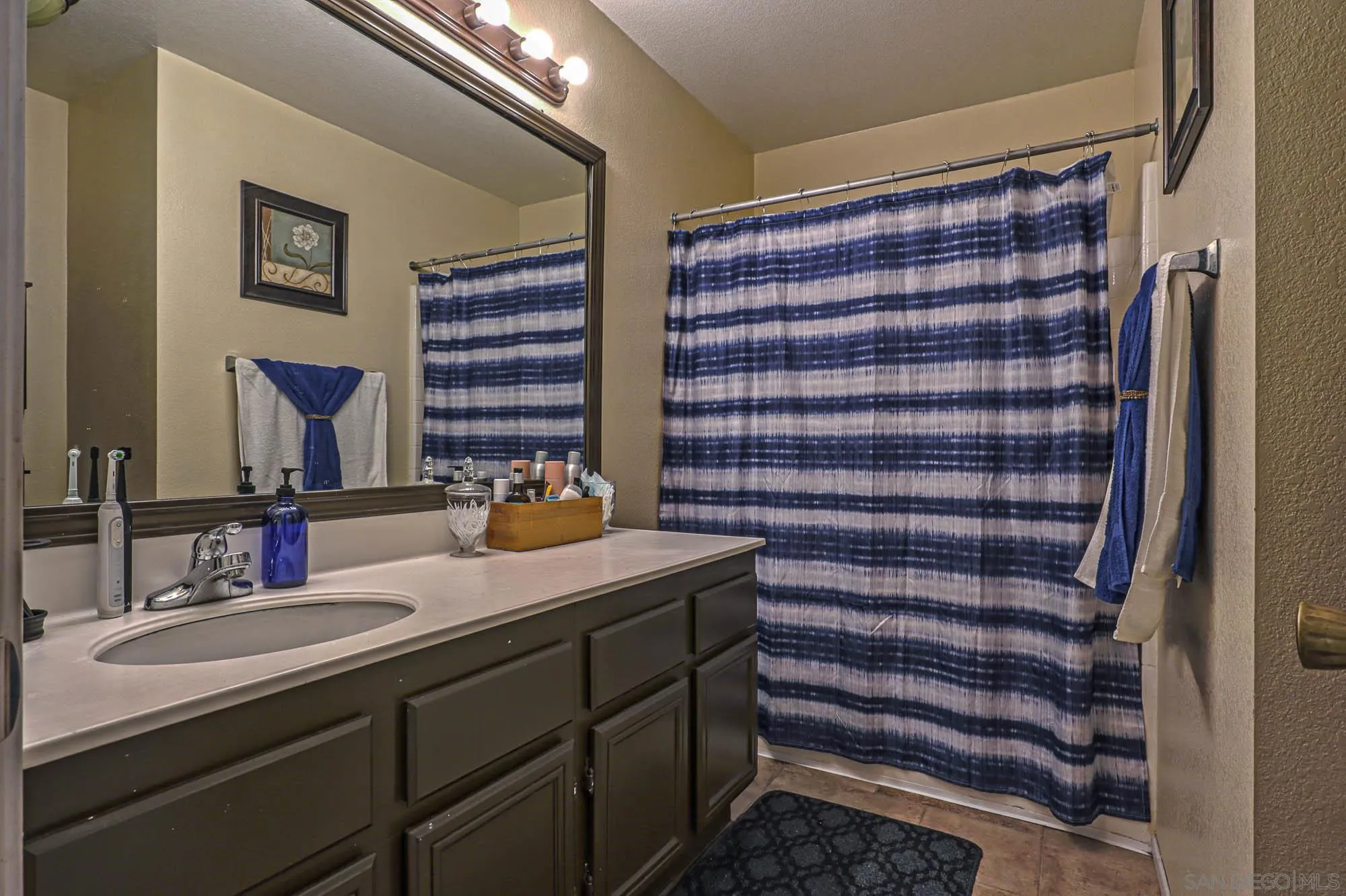 914 Rigley Street Chula Vista, CA 91911 - Photo 26 of 35 a bathroom with a sink and a mirror
