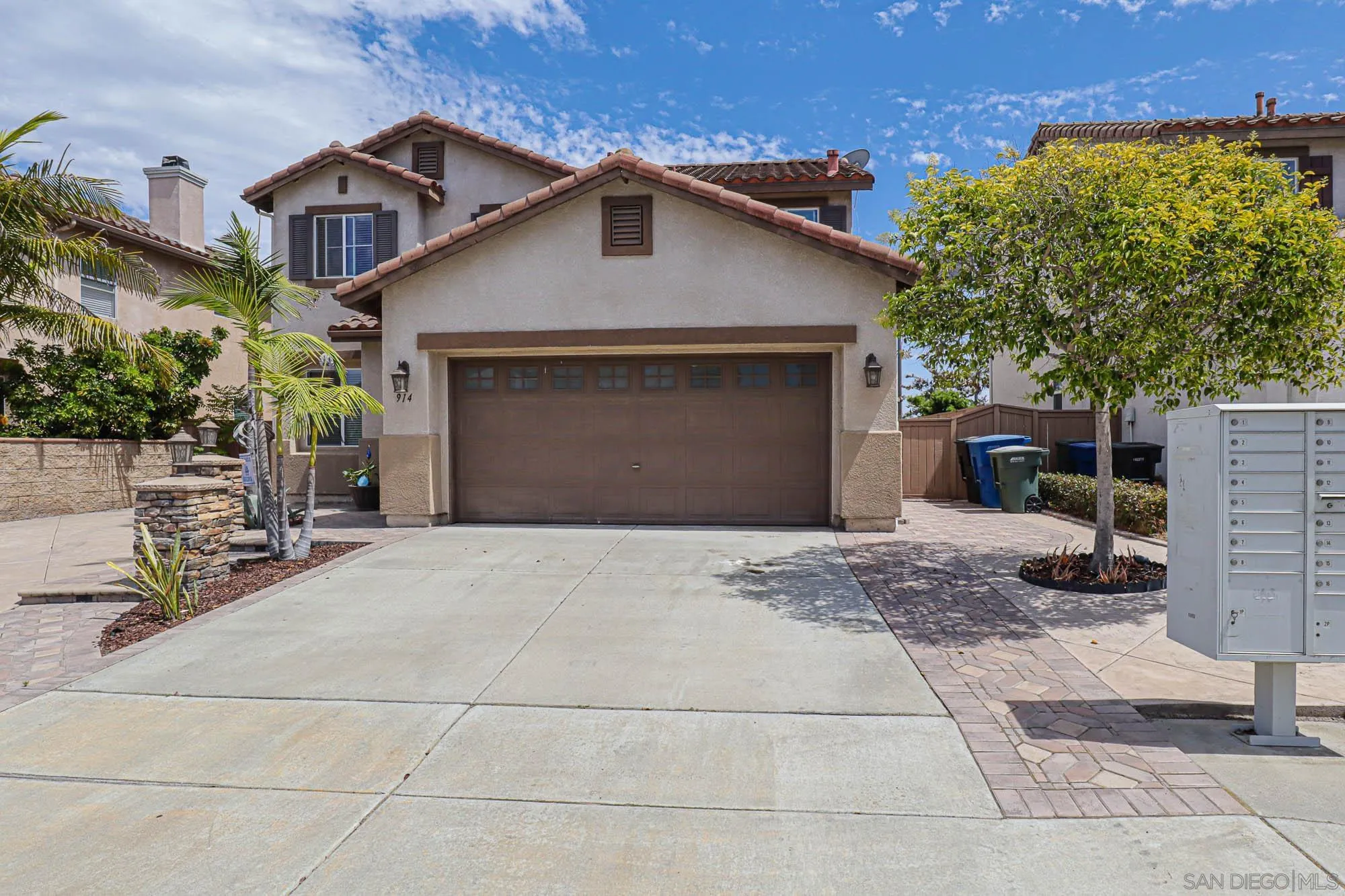914 Rigley Street Chula Vista, CA 91911 - Photo 3 of 35 a front view of a house with a yard and garage