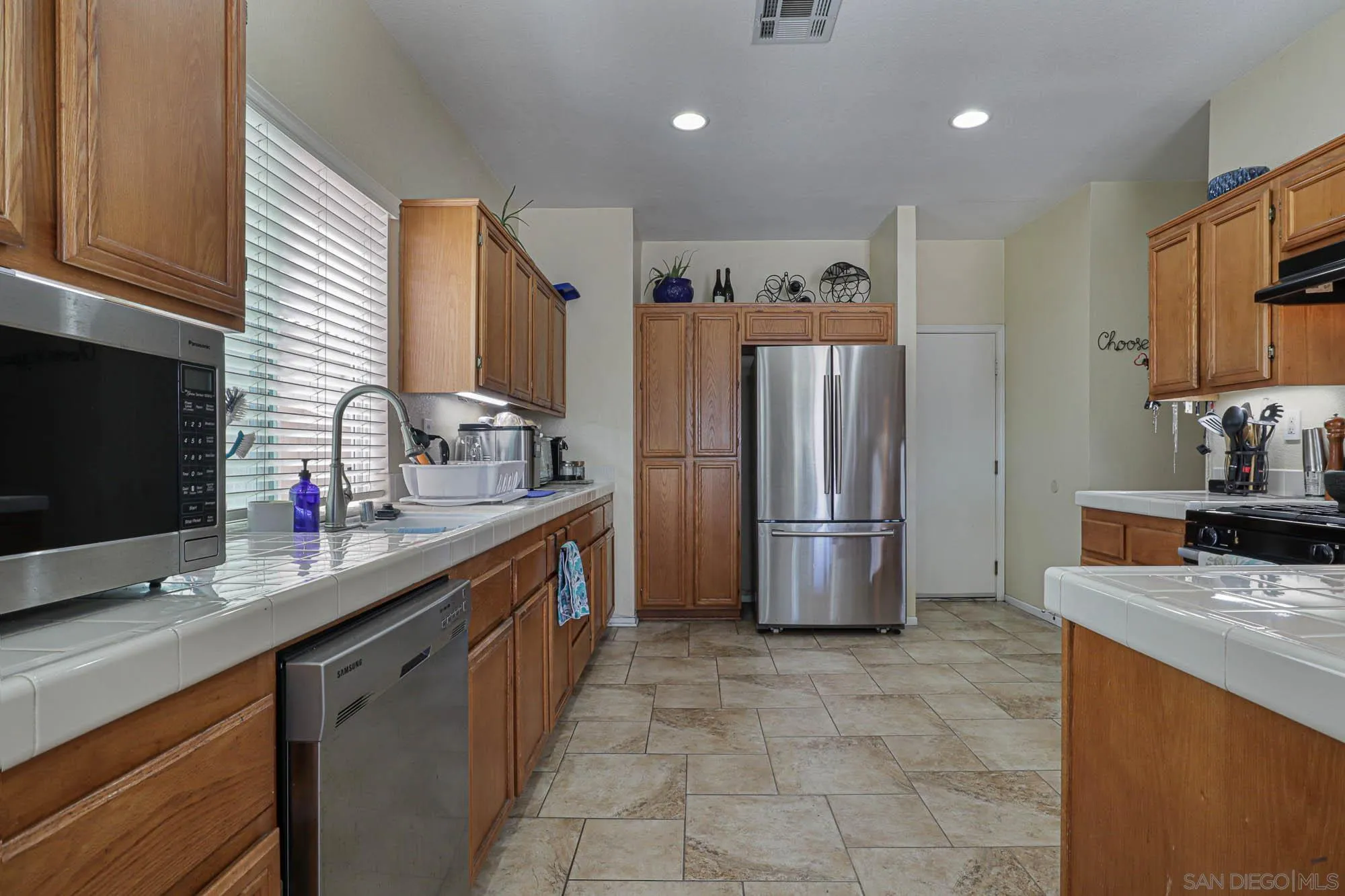 914 Rigley Street Chula Vista, CA 91911 - Photo 8 of 35 a kitchen with stainless steel appliances a refrigerator sink and stove