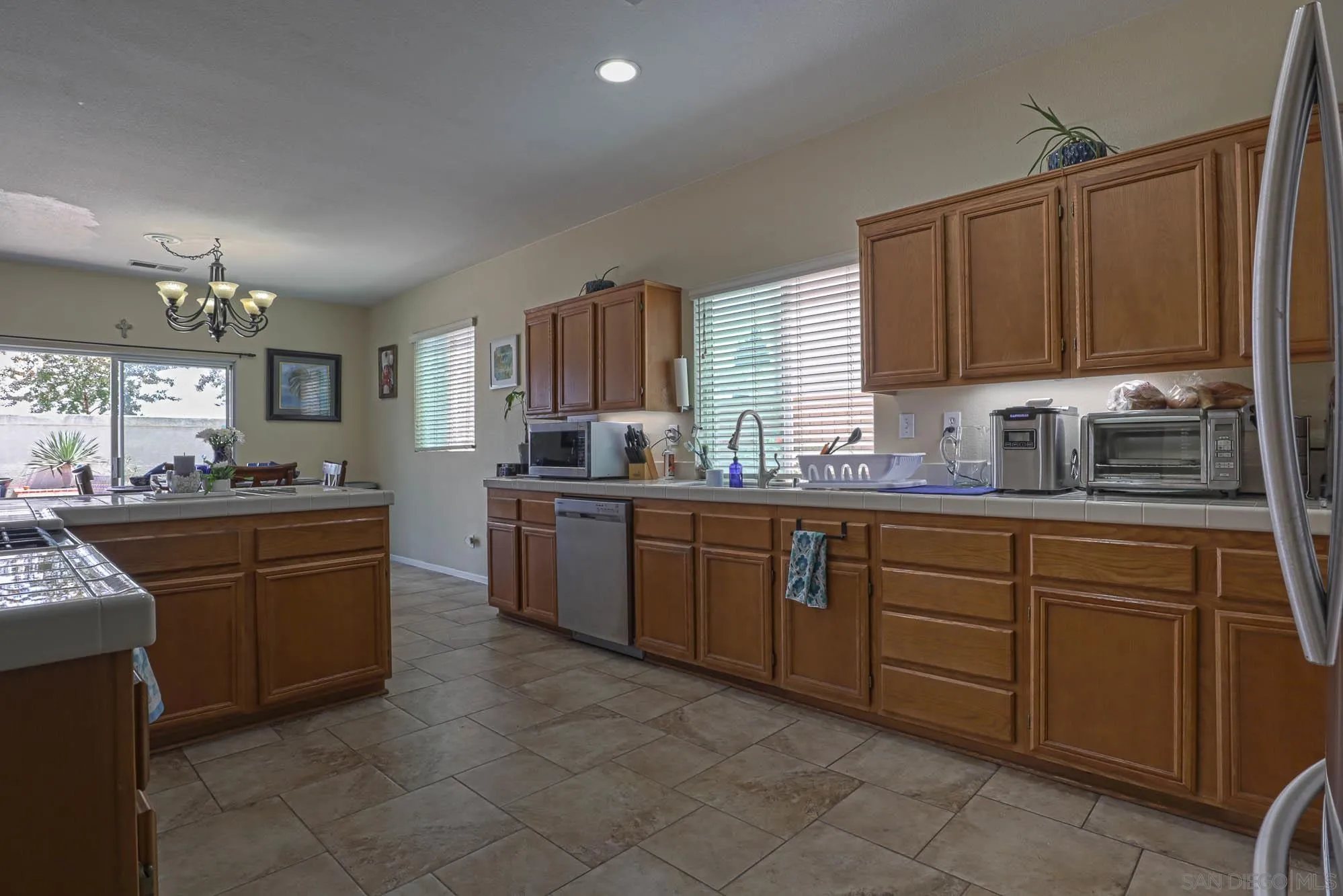 914 Rigley Street Chula Vista, CA 91911 - Photo 10 of 35 a kitchen with granite countertop a sink counter top space appliances and cabinets