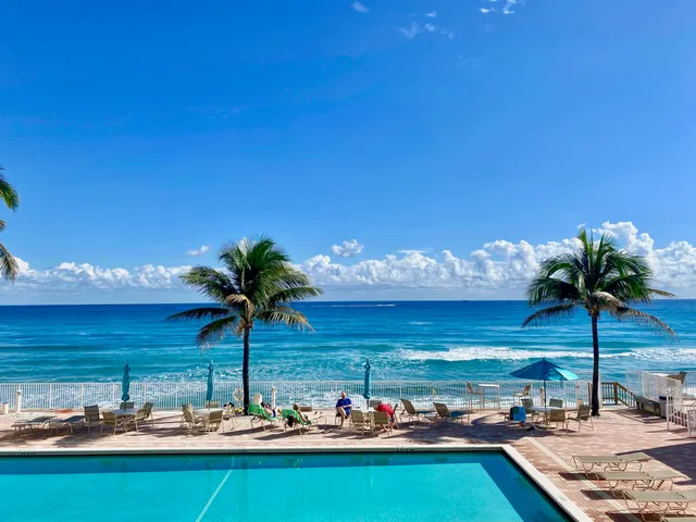 a view of a swimming pool with an outdoor seating