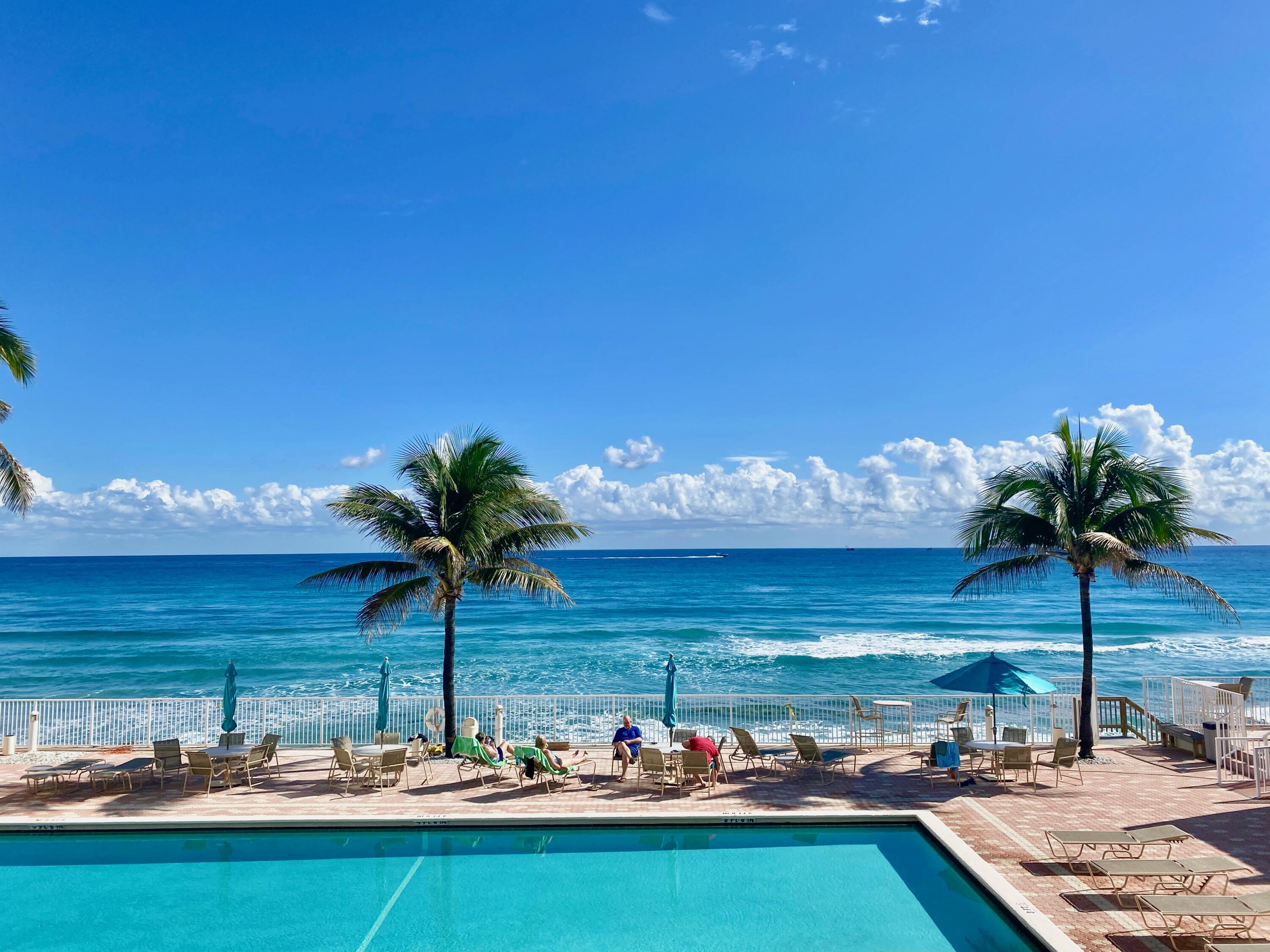 a view of a swimming pool with an outdoor seating