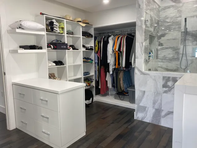 a bedroom with a large bed and a large window