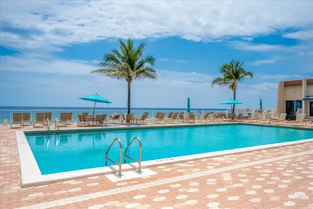 a view of a lake with a table and chairs