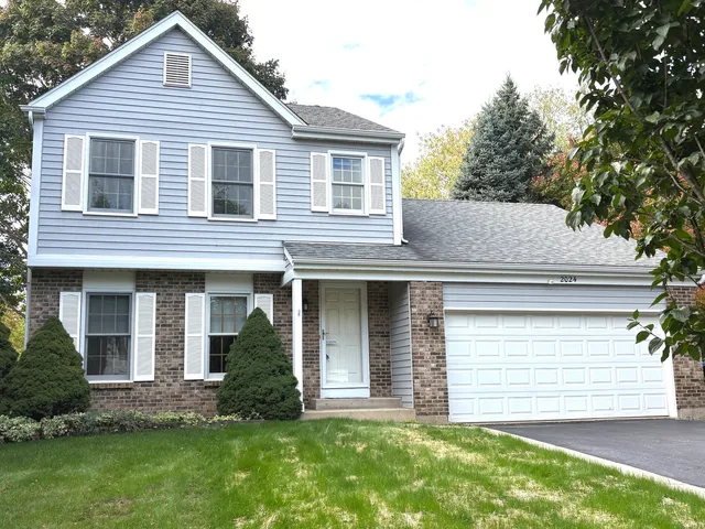 a view of a house with a yard and plants