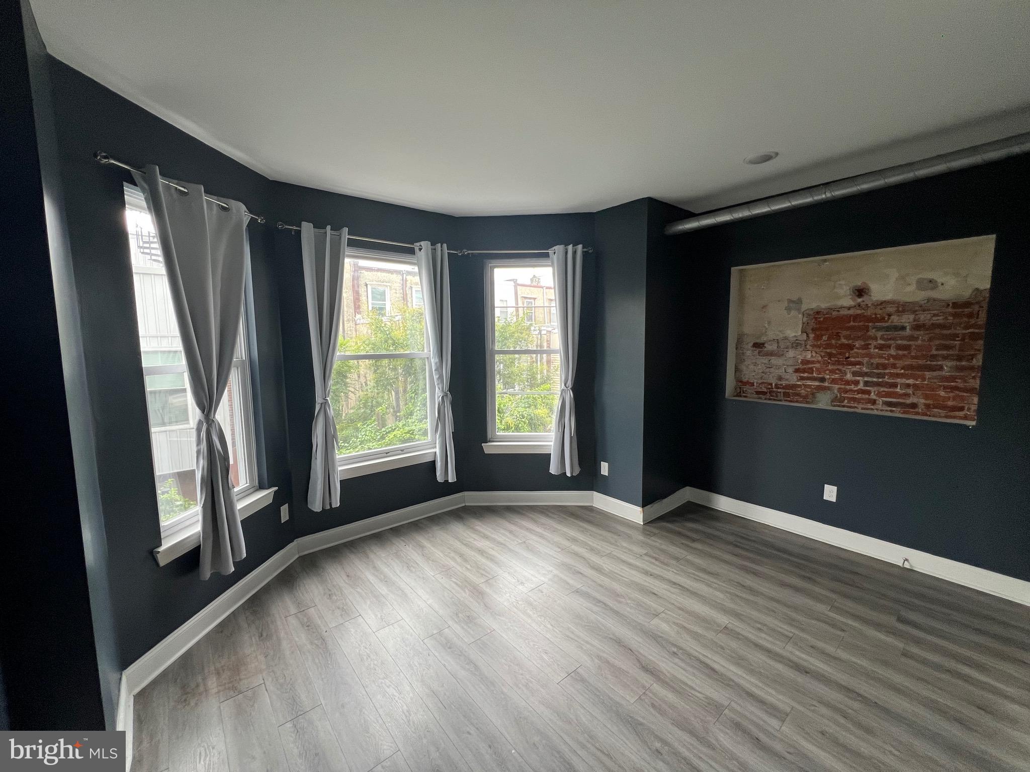 1829 North 33rd Street, Unit 2R Philadelphia, PA 19121 - Photo 4 of 7 a view of an empty room with glass door and wooden floor