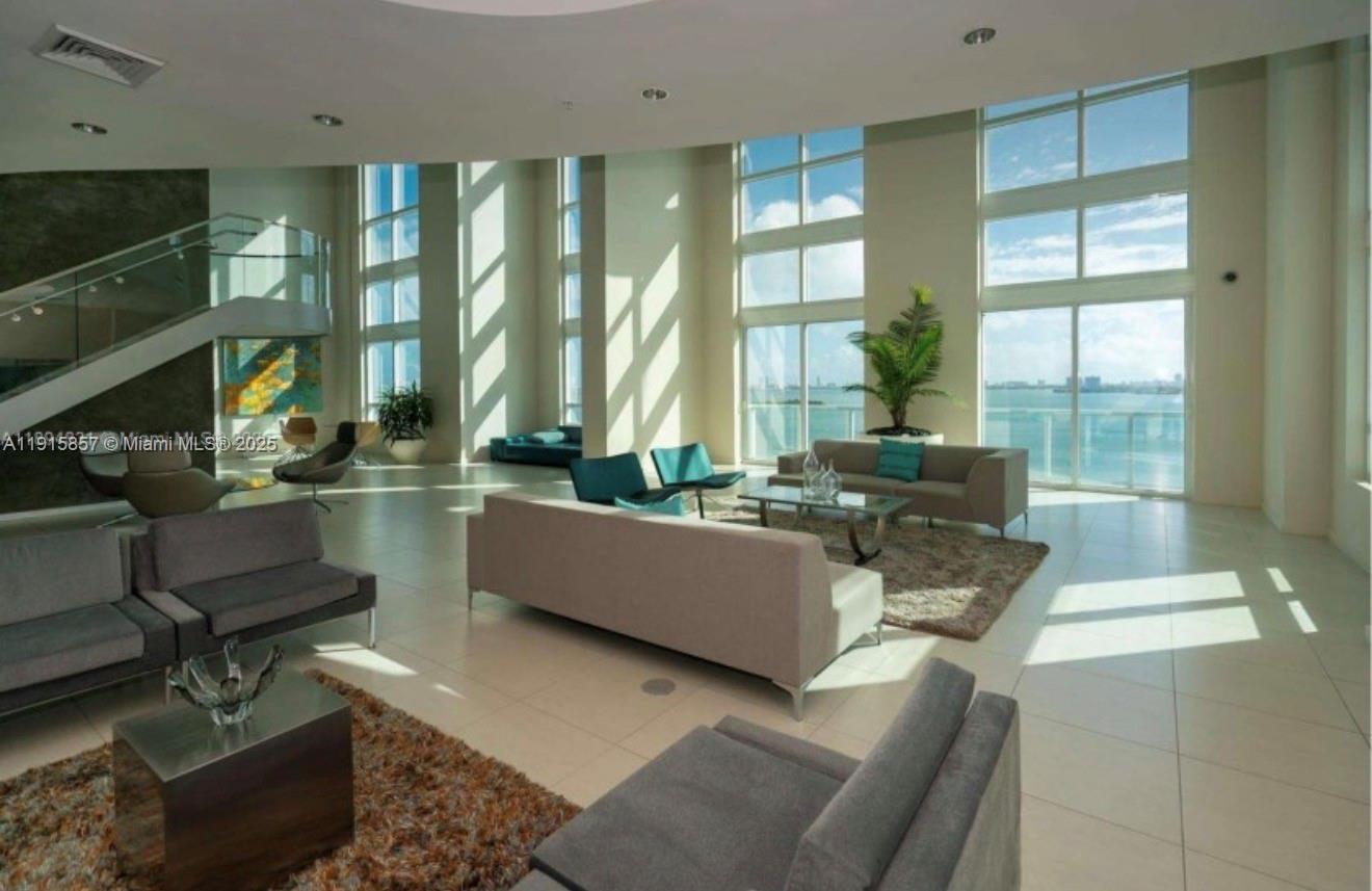 1900 North Bayshore Drive, Unit 3811 Miami, FL 33132 - Photo 17 of 27 a living room with couches coffee table and a fireplace