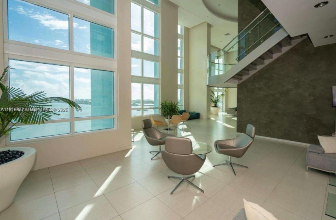 1900 North Bayshore Drive, Unit 3811 Miami, FL 33132 - Photo 18 of 27 a living room with patio furniture and a potted plant