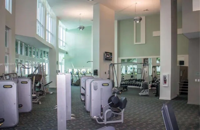 a front view of a house with fountain and potted plants