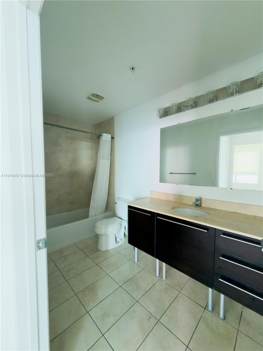 1900 North Bayshore Drive, Unit 3811 Miami, FL 33132 - Photo 8 of 27 a bathroom with a sink a toilet and a mirror