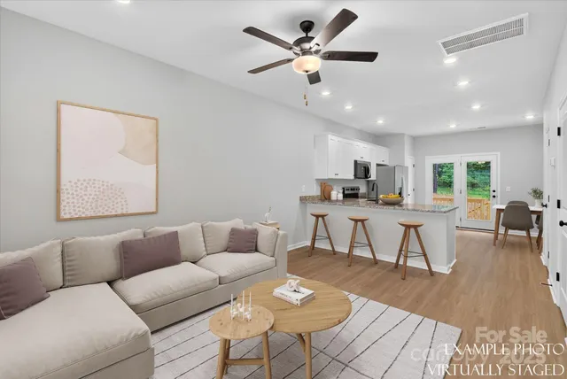 a living room with furniture and kitchen view