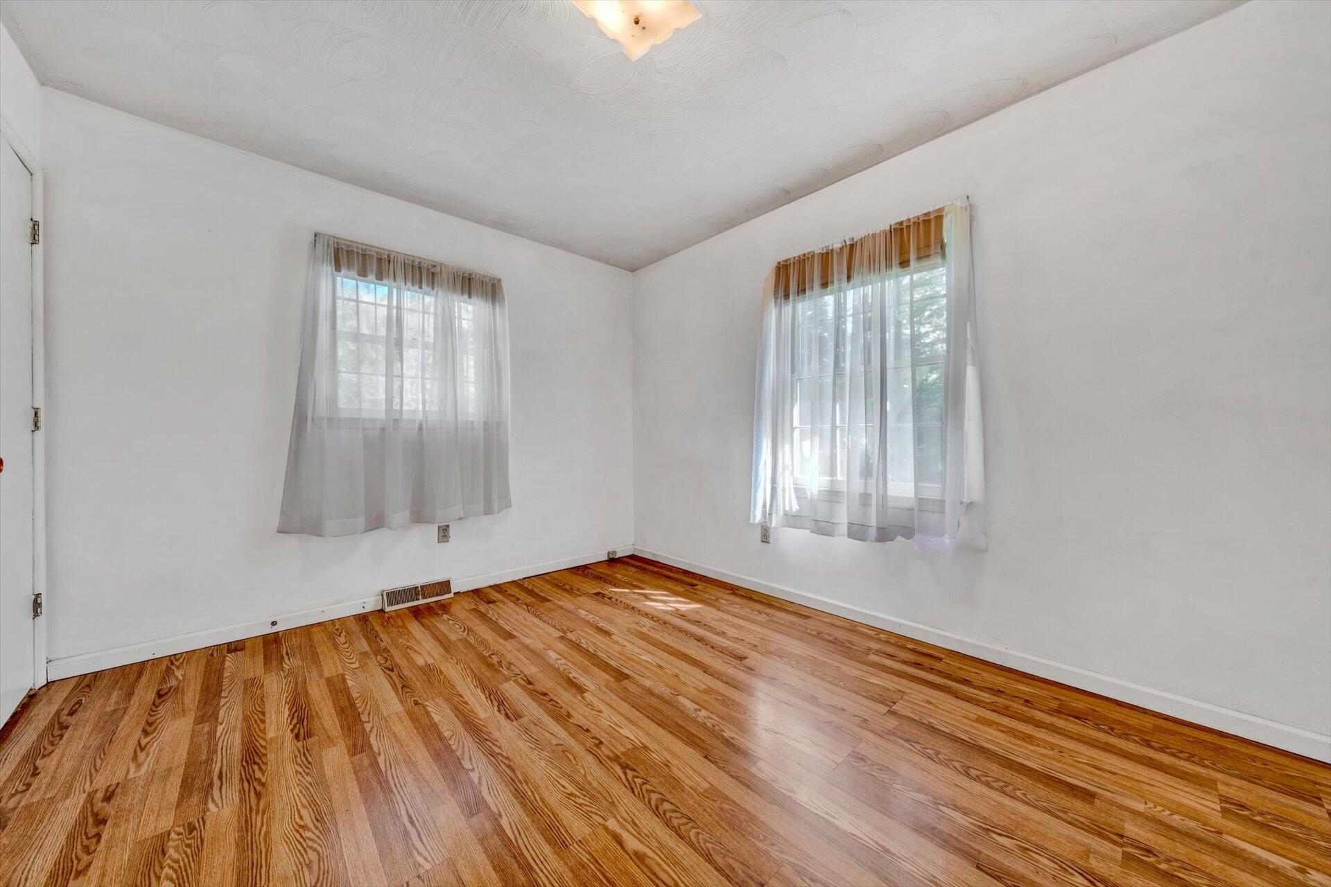 1319 Chandler Road Goodview, VA 24095 - Photo 27 of 53 a view of an empty room with wooden floor and a window