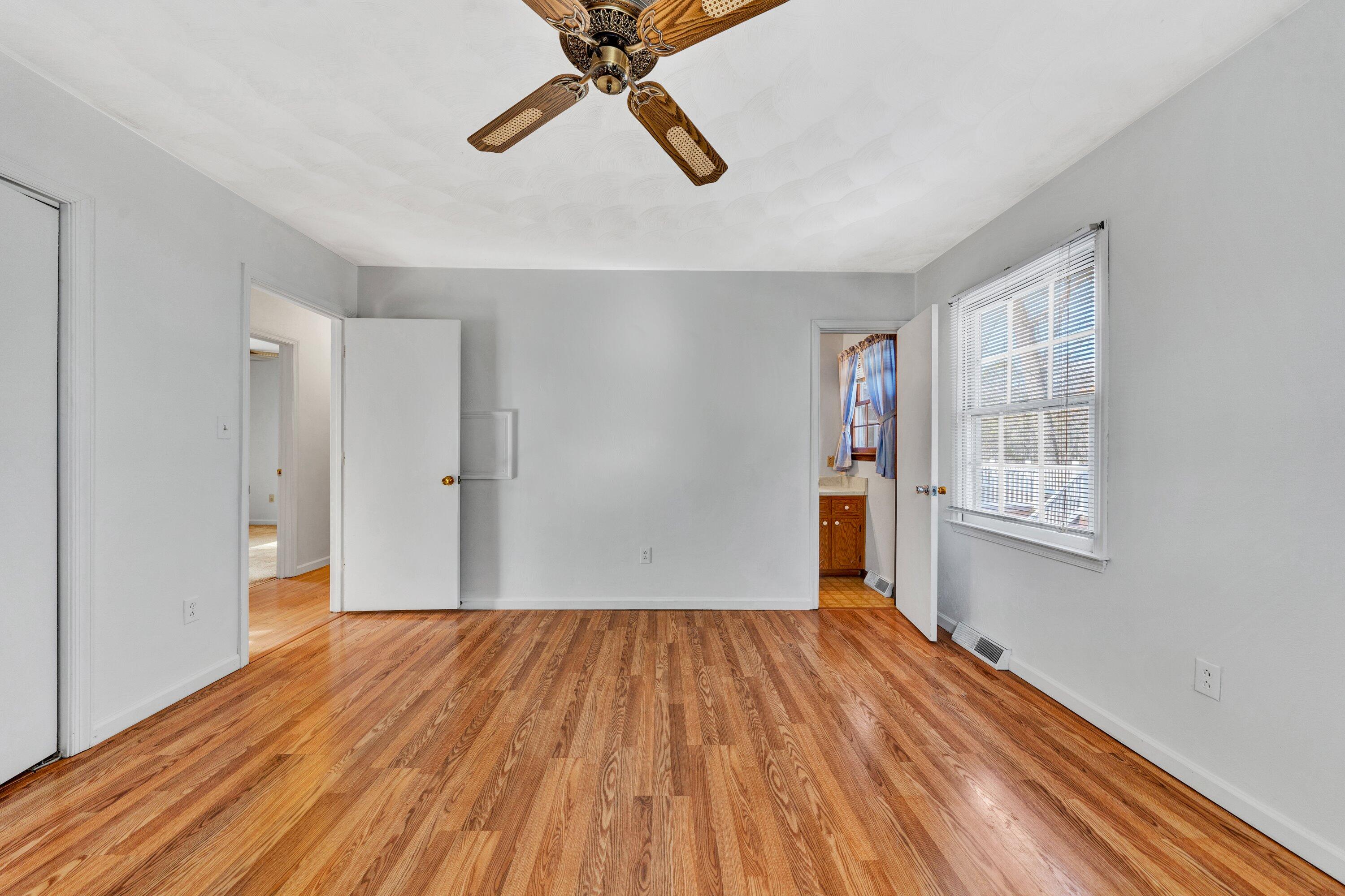 1319 Chandler Road Goodview, VA 24095 - Photo 29 of 53 a view of an empty room with wooden floor and a window