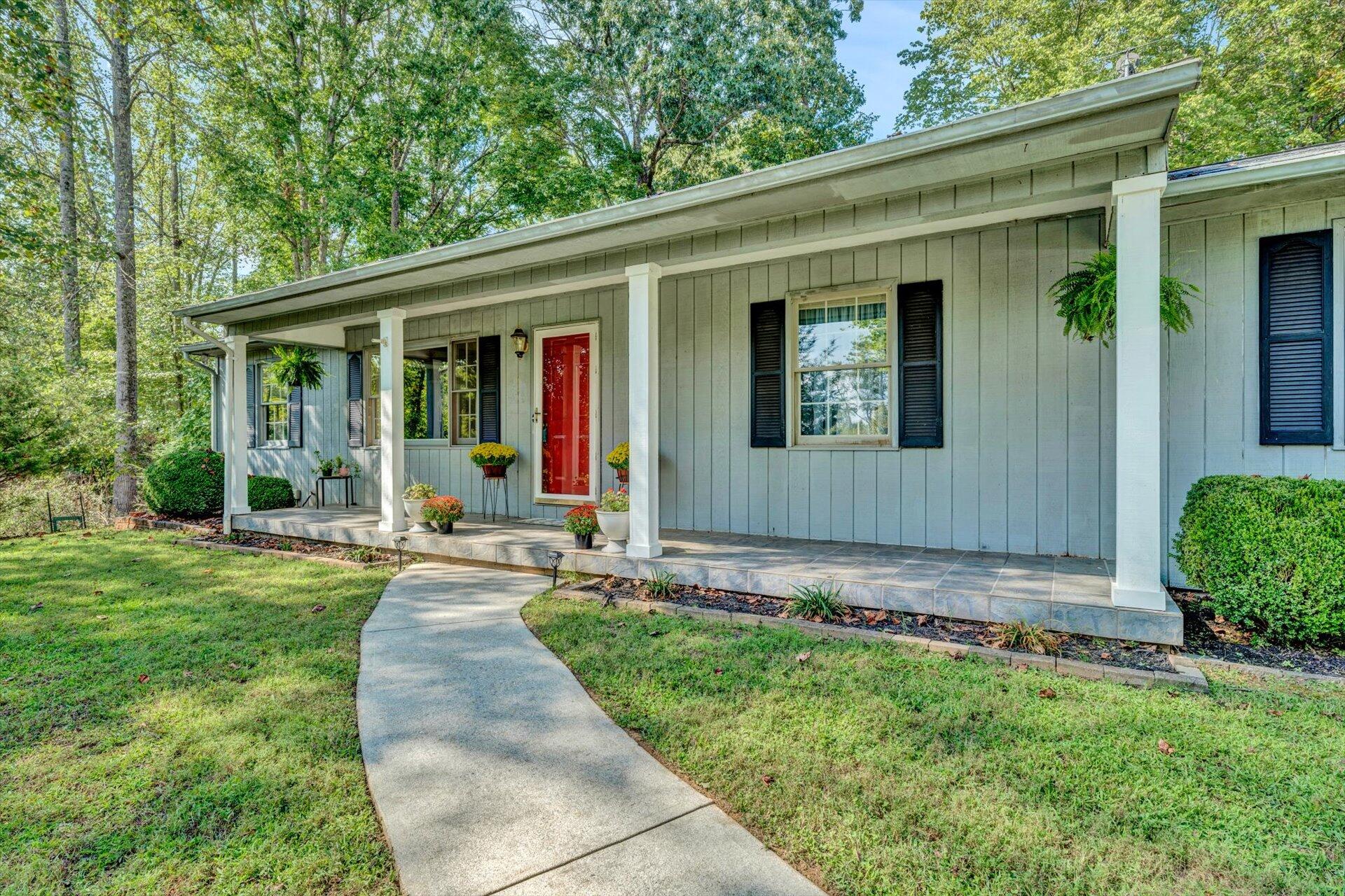 1319 Chandler Road Goodview, VA 24095 - Photo 6 of 53 a front view of a house with a yard and potted plants