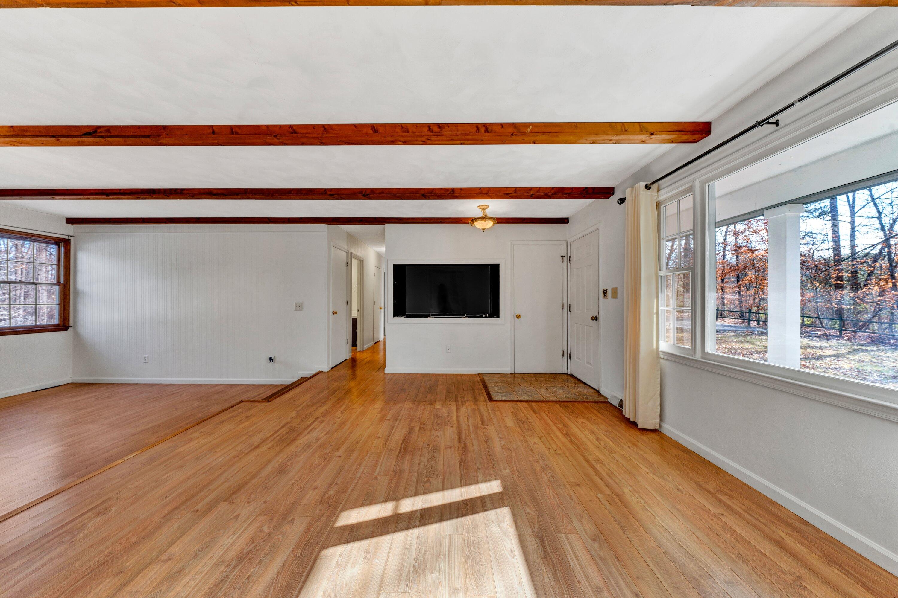 1319 Chandler Road Goodview, VA 24095 - Photo 8 of 53 a view of empty room with wooden floor and fan