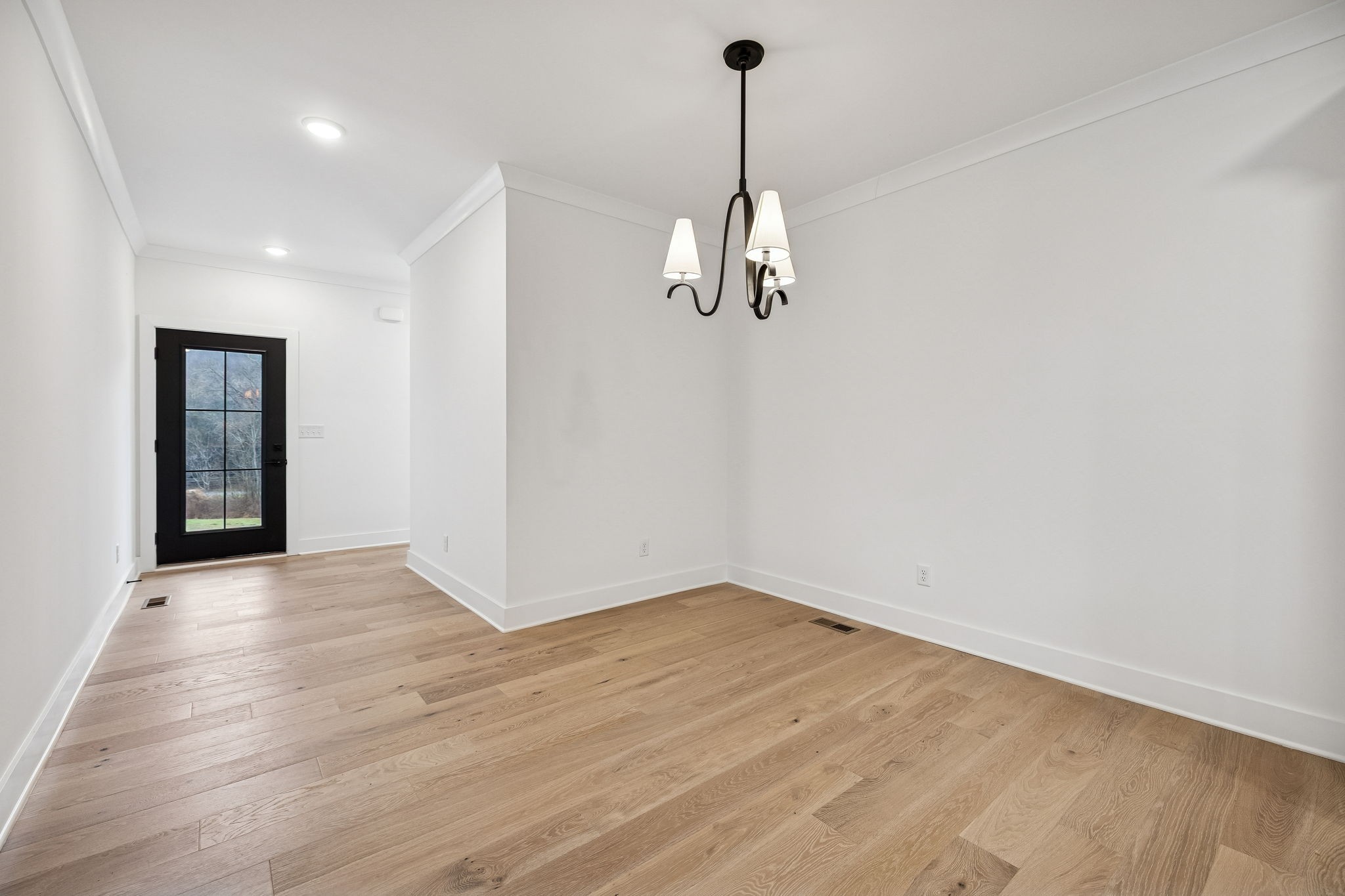1501 Opossum Paw Road Beechgrove, TN 37018 - Photo 13 of 55 a view of a room with a chandelier fan and wooden floor