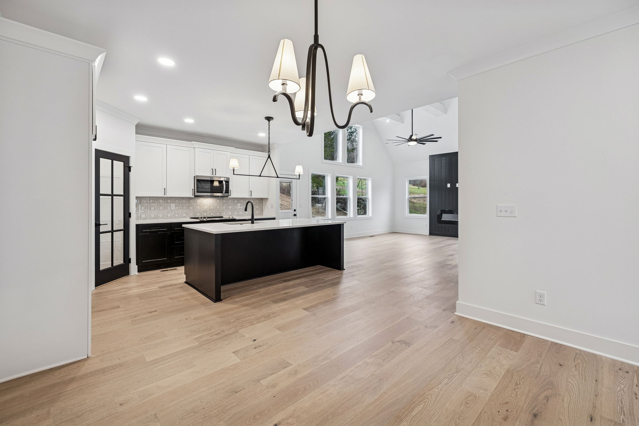 1501 Opossum Paw Road Beechgrove, TN 37018 - Photo 16 of 55 a large kitchen with stainless steel appliances a large counter top a sink and a chandelier
