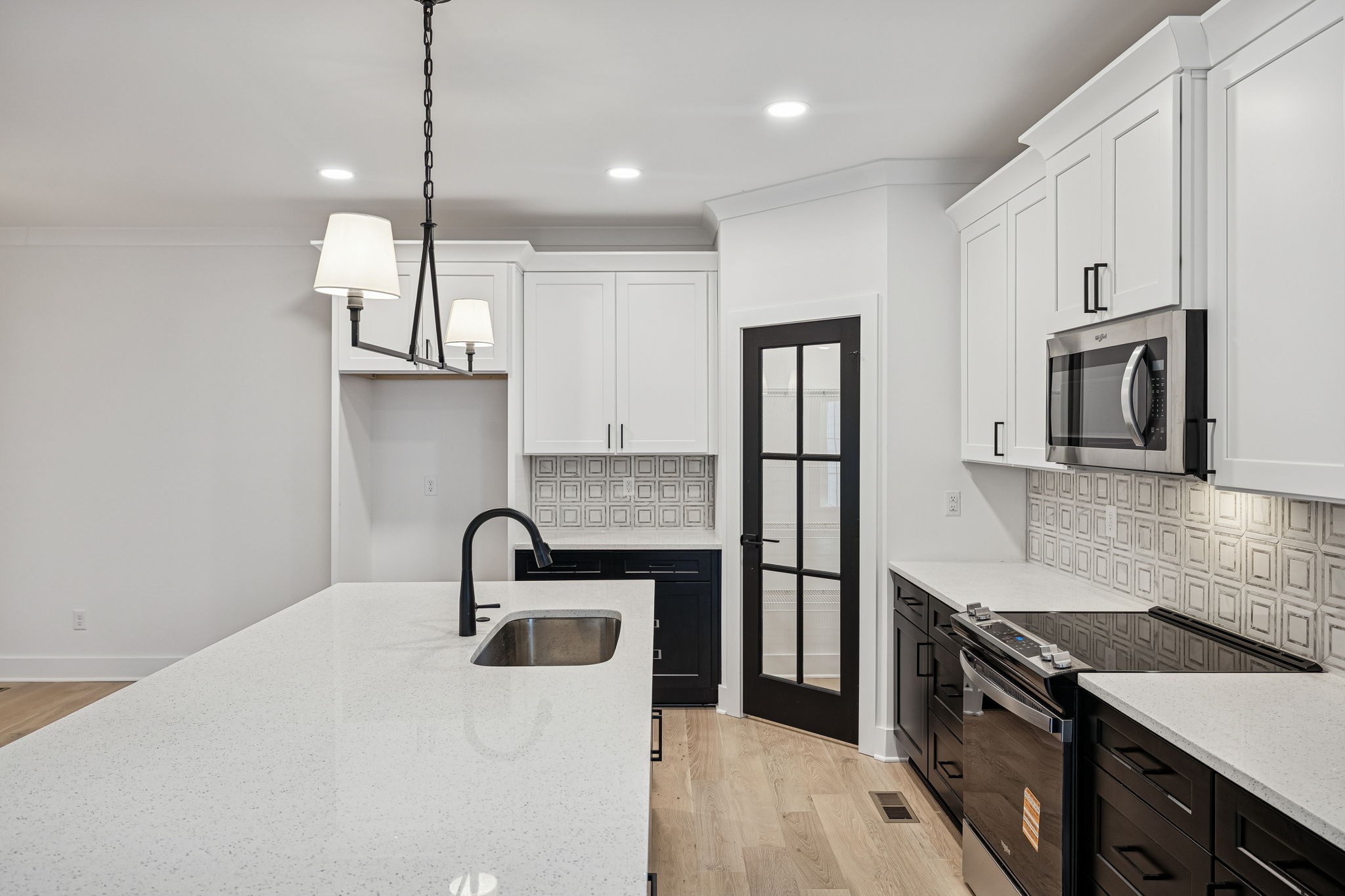 1501 Opossum Paw Road Beechgrove, TN 37018 - Photo 18 of 55 a kitchen with stainless steel appliances granite countertop a sink a stove and a refrigerator