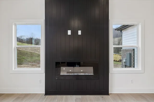 an empty room with ceiling fan and window