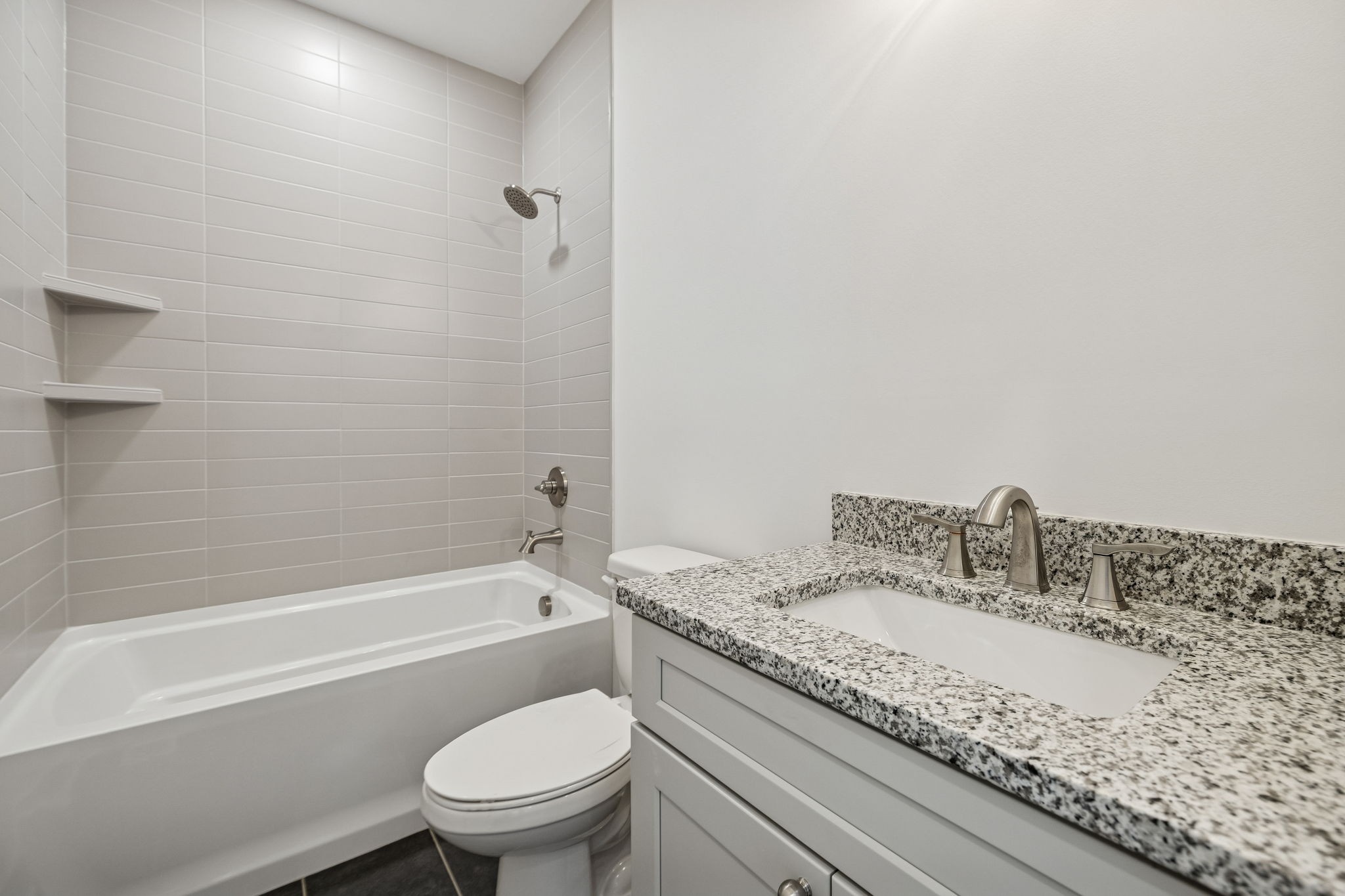 1501 Opossum Paw Road Beechgrove, TN 37018 - Photo 45 of 55 a bathroom with a granite countertop sink a toilet and bathtub