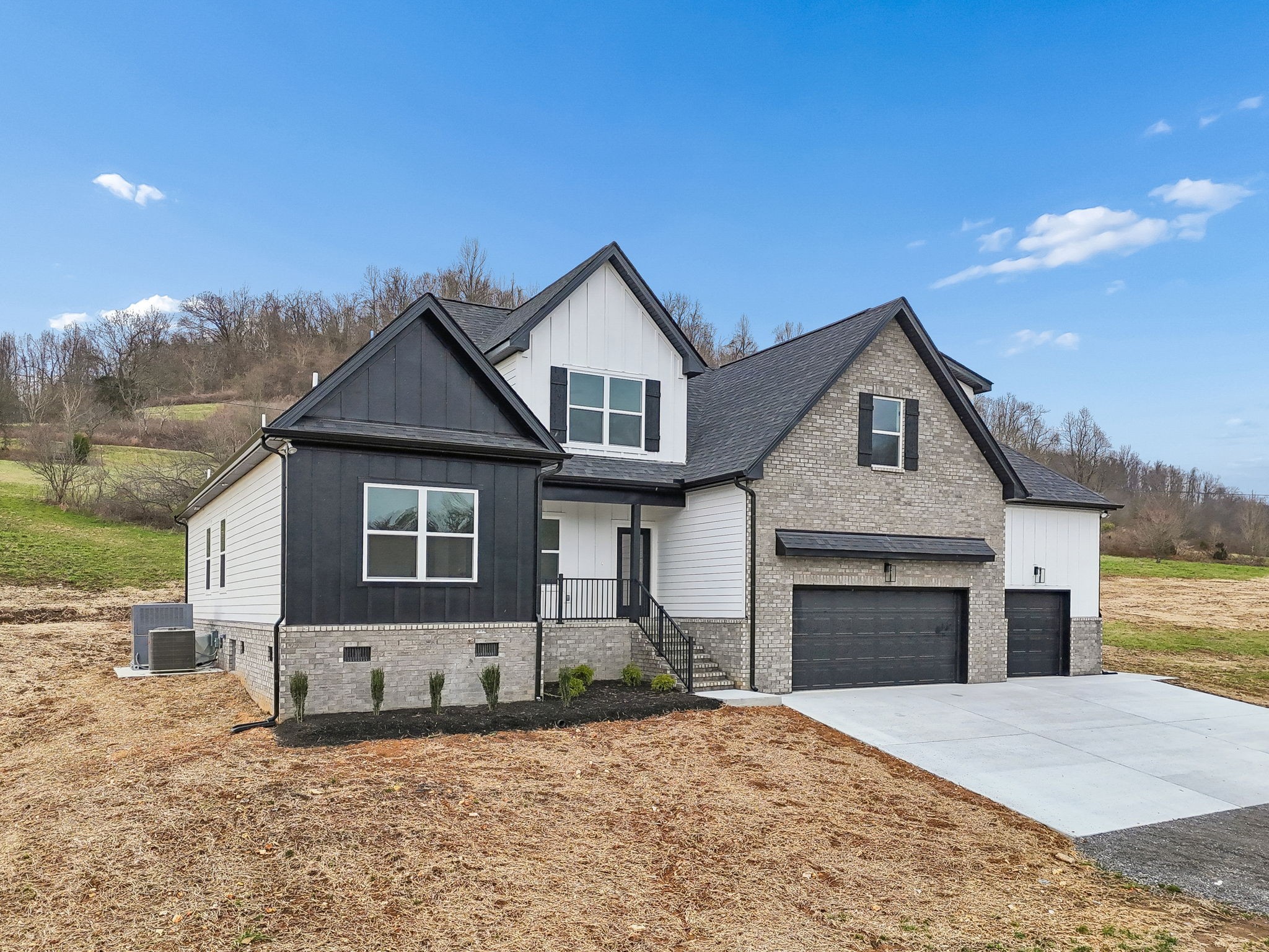 1501 Opossum Paw Road Beechgrove, TN 37018 - Photo 5 of 55 a front view of a house with a yard and garage