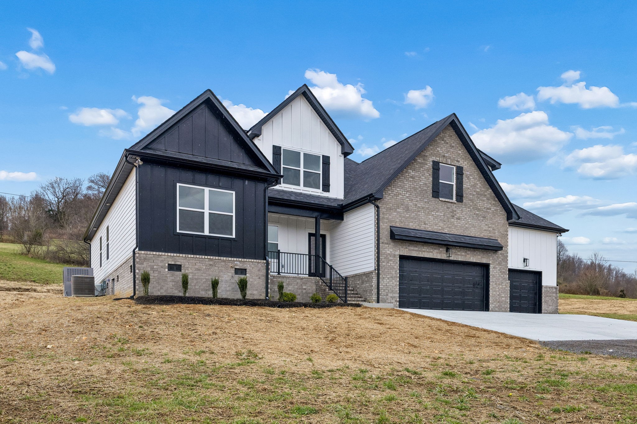 1501 Opossum Paw Road Beechgrove, TN 37018 - Photo 6 of 55 a front view of a house with a yard and garage