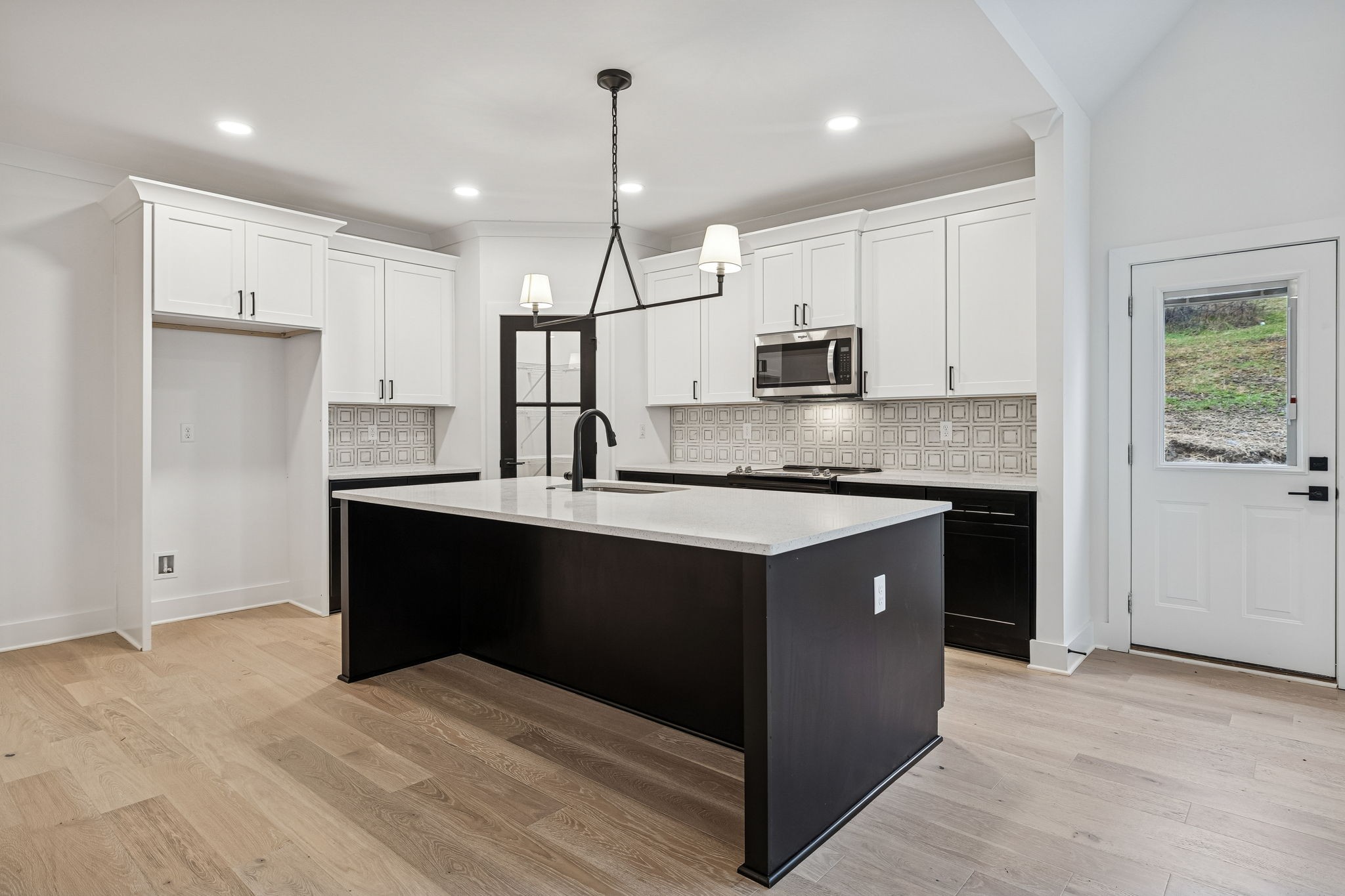1501 Opossum Paw Road Beechgrove, TN 37018 - Photo 8 of 55 a kitchen with kitchen island granite countertop a refrigerator a sink dishwasher a stove and white cabinets with wooden floor