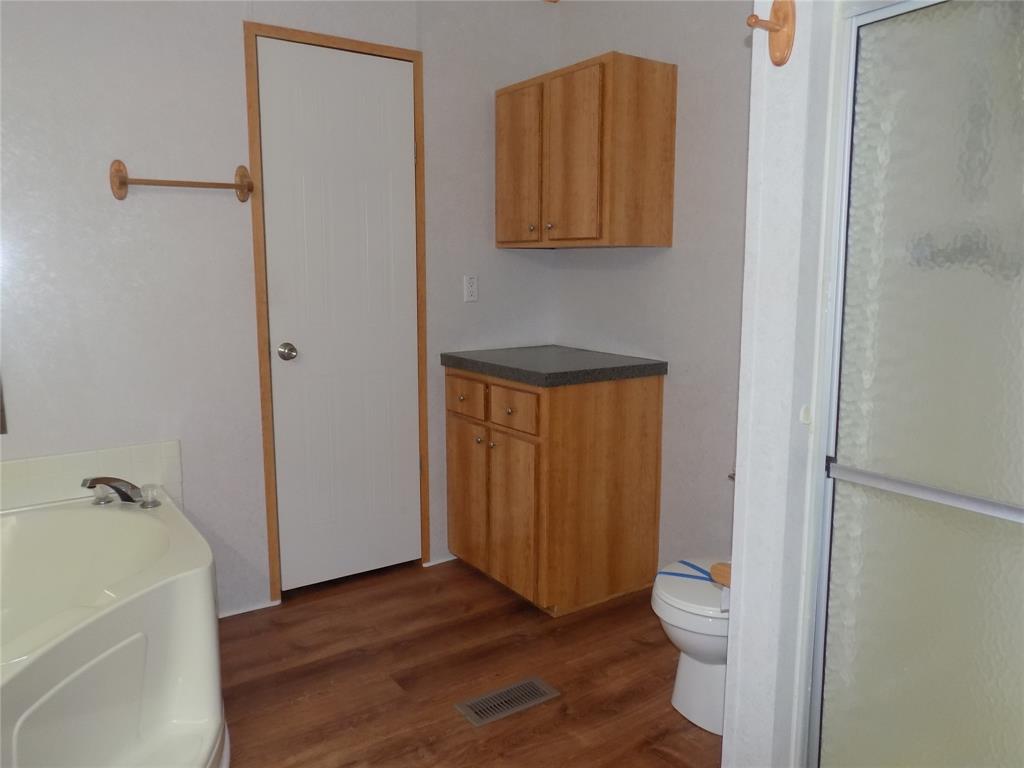 12792 Highway 199 Poolville, TX 76487 - Photo 19 of 24 Master bathroom closet and extra cabinets