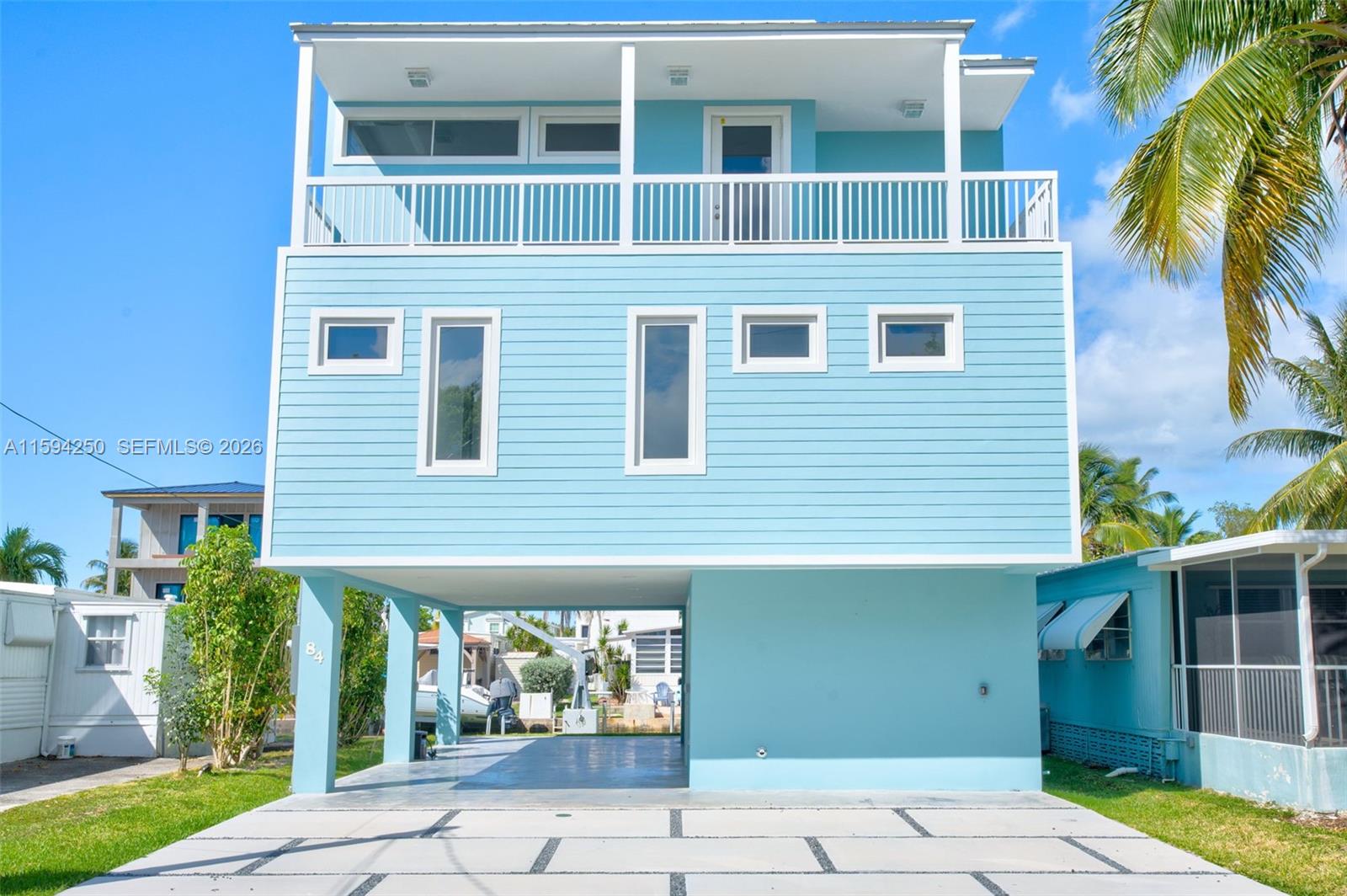 84 Coral Way Key Largo, FL 33037 - Photo 45 of 55 a front view of a house with garden