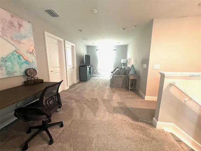 a dining room with furniture and a large window