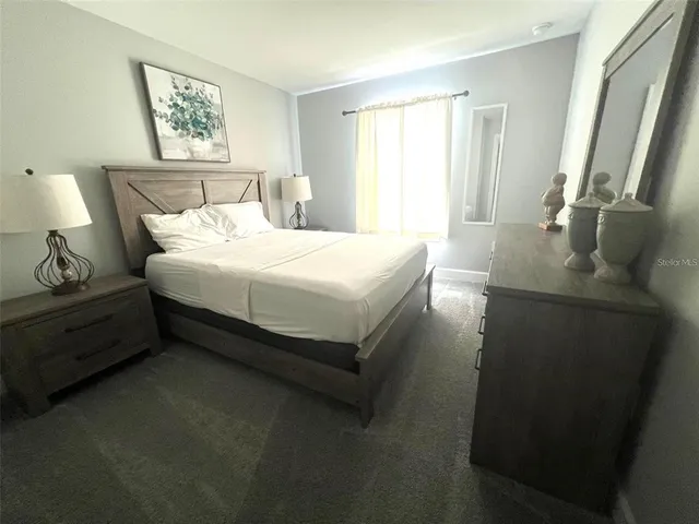 a spacious bedroom with a bed and a window