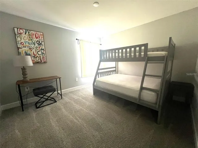 a bedroom with a bed a desk and chair