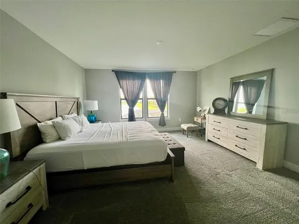 a bedroom with a bed and a dresser