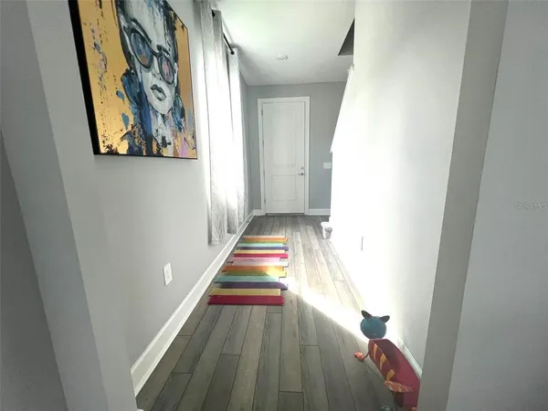 a view of an entryway with wooden floor