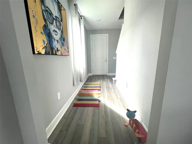 a view of an entryway with wooden floor