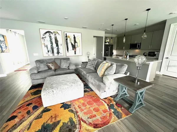 a living room with furniture and wooden floor
