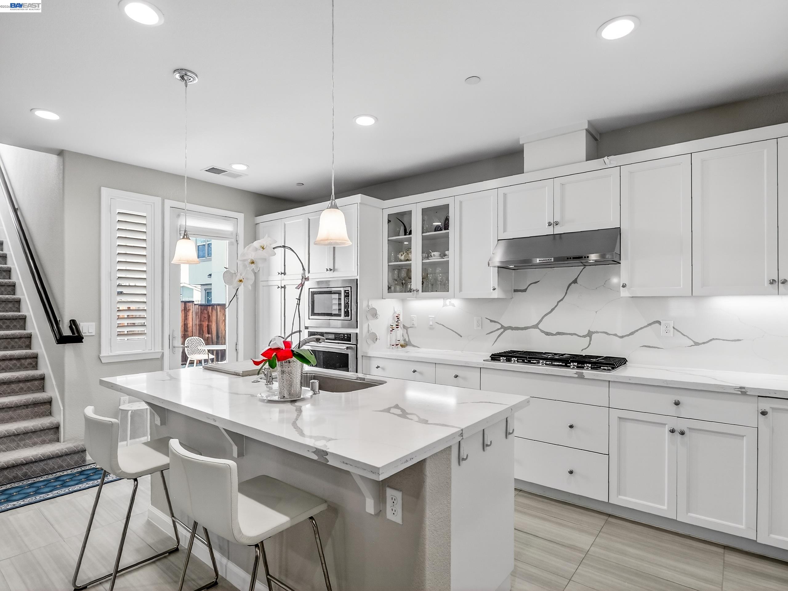5030 Brook Valley Loop San Jose, CA 95136 - Photo 11 of 37 a kitchen with stainless steel appliances kitchen island granite countertop a sink and cabinets