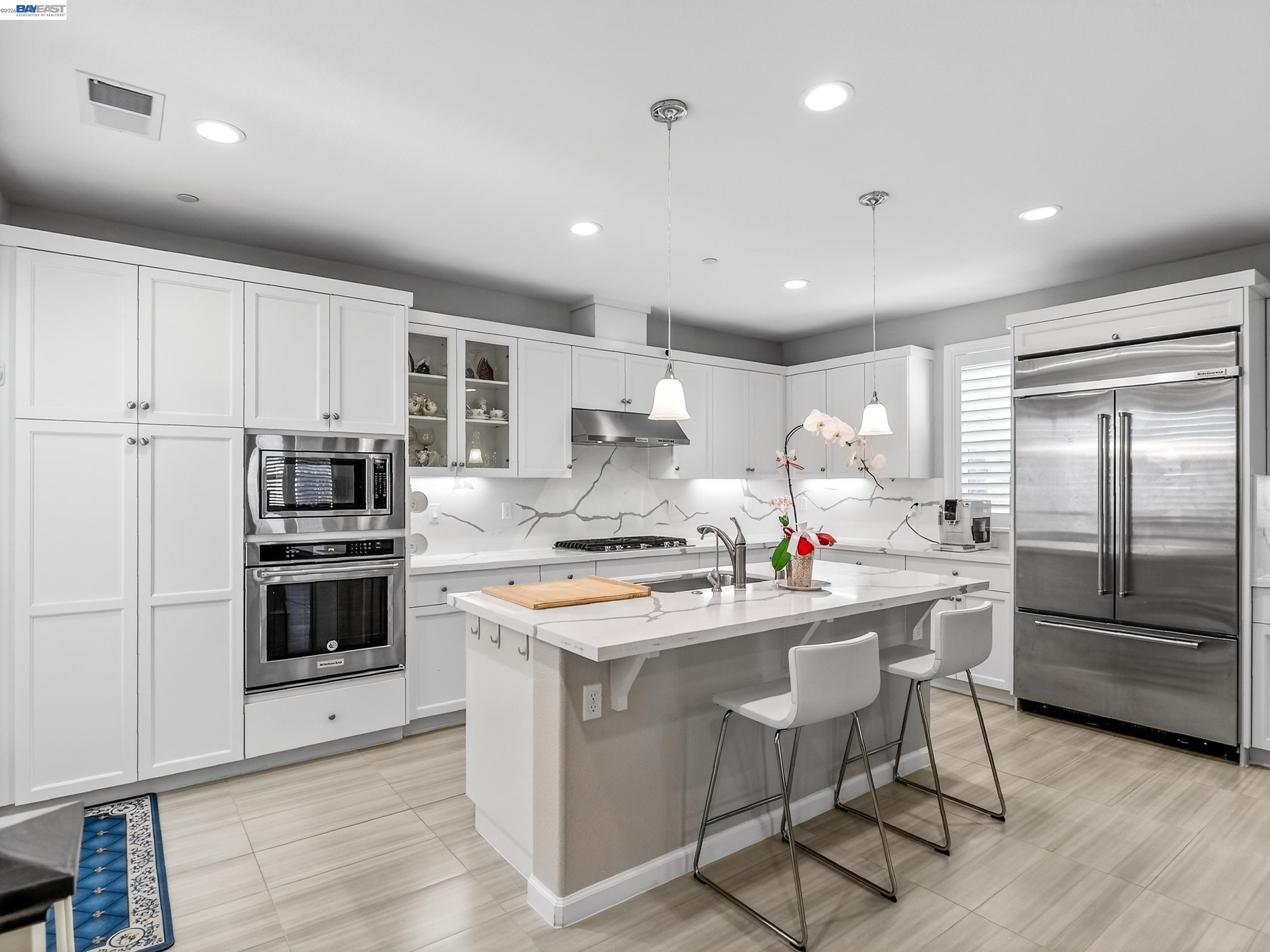 5030 Brook Valley Loop San Jose, CA 95136 - Photo 12 of 37 a kitchen that has a lot of cabinets in it and wooden floors