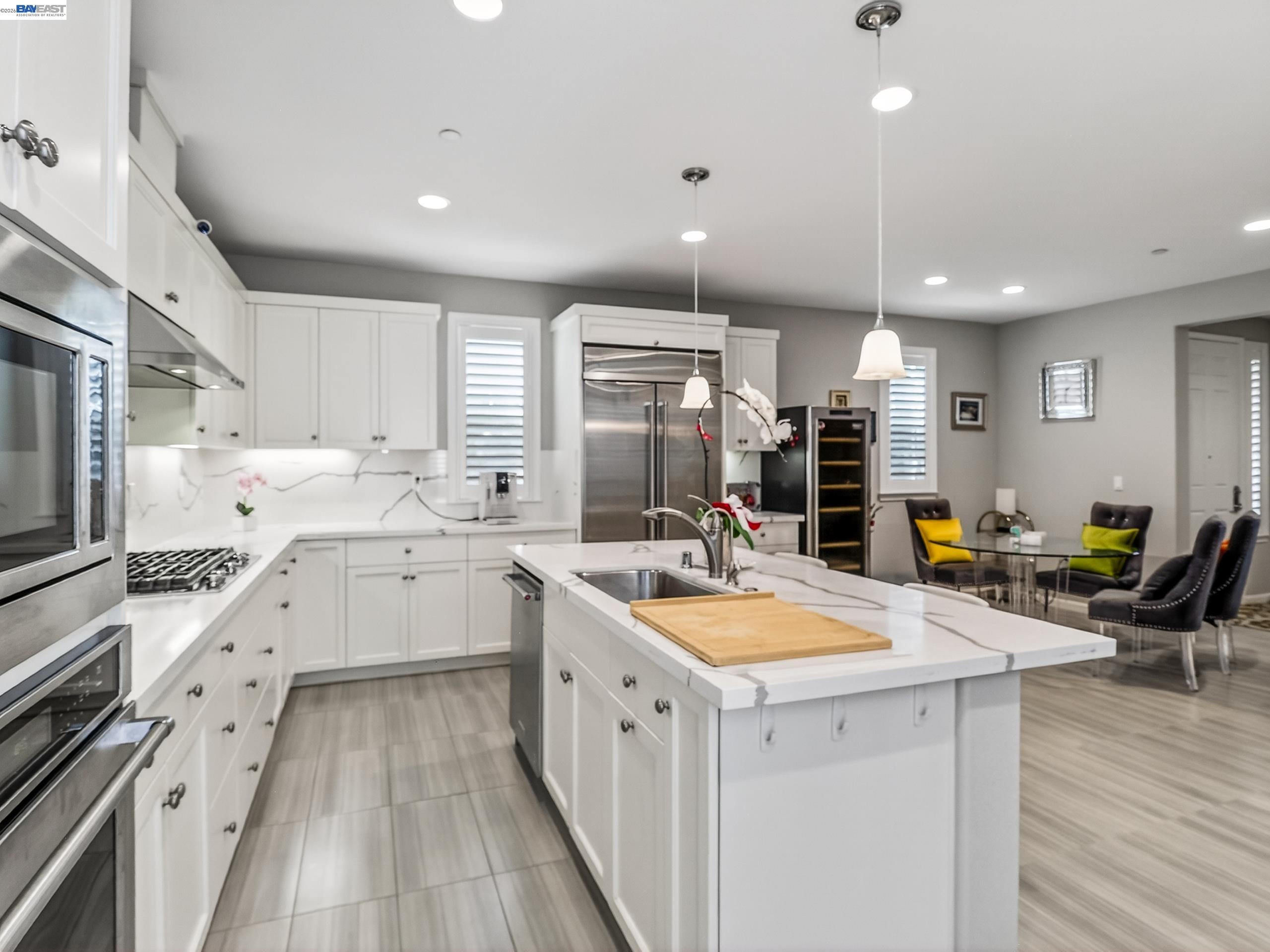 5030 Brook Valley Loop San Jose, CA 95136 - Photo 13 of 37 a kitchen with white cabinets appliances and wooden floor