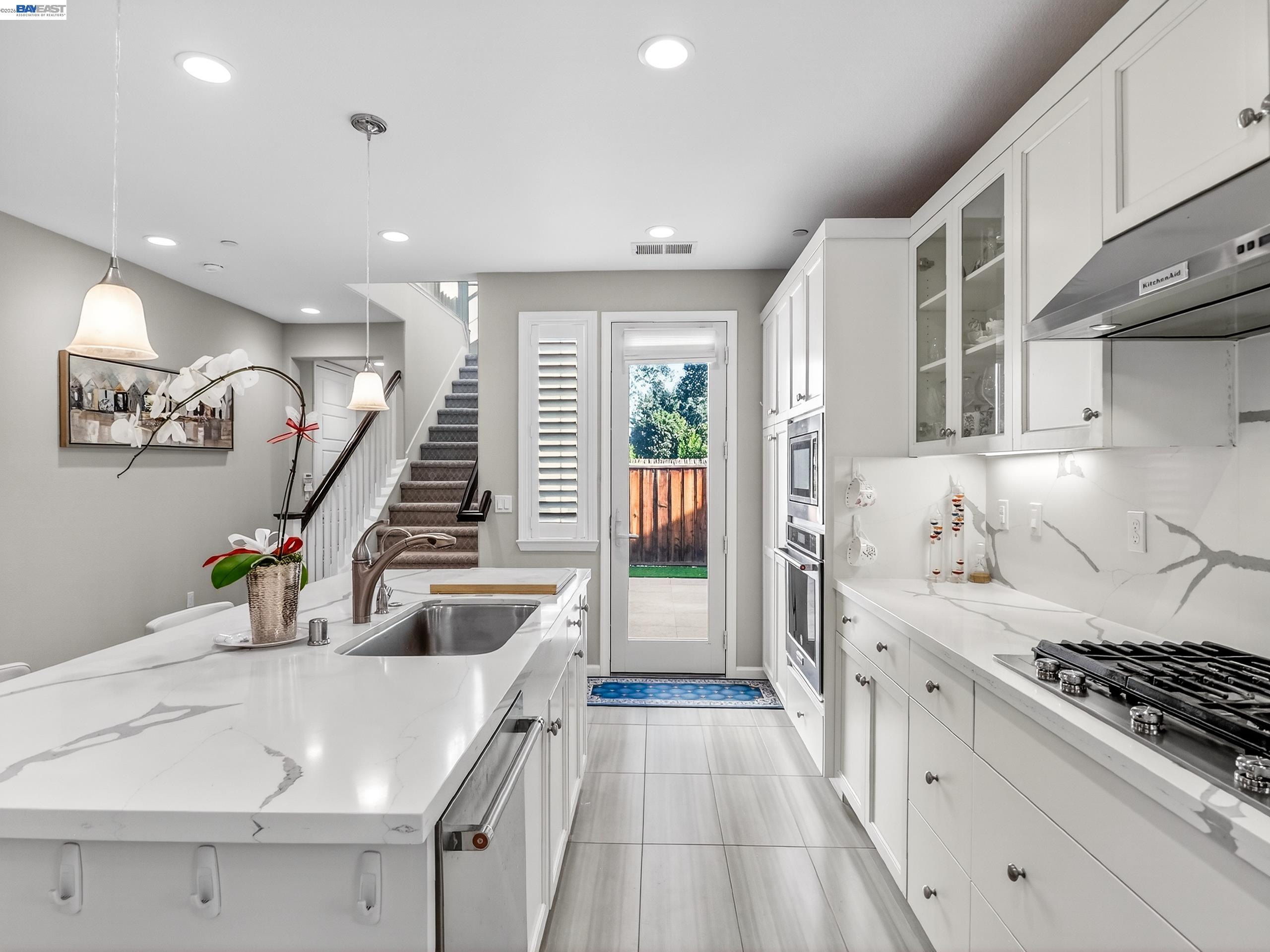 5030 Brook Valley Loop San Jose, CA 95136 - Photo 15 of 37 a kitchen with granite countertop a sink stove and cabinets