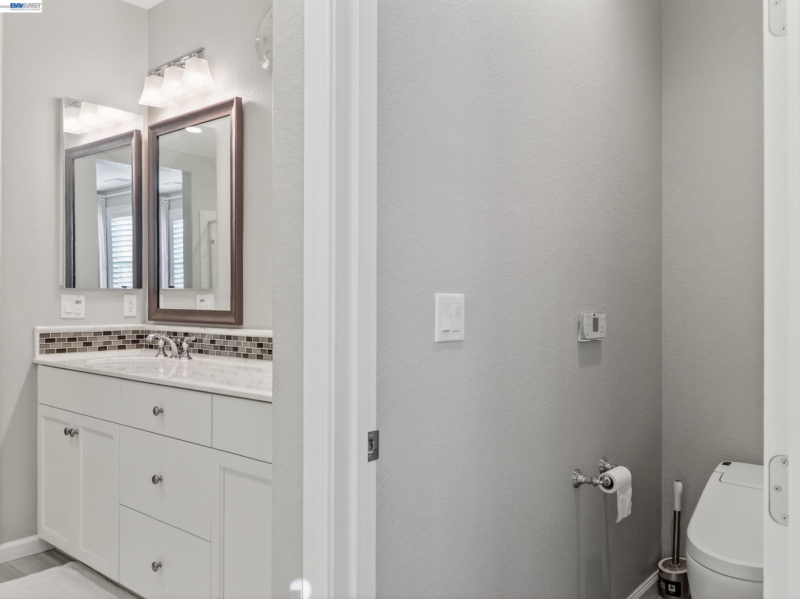 5030 Brook Valley Loop San Jose, CA 95136 - Photo 26 of 37 a bathroom with a granite countertop sink toilet and mirror