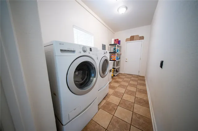 a room with gym equipment and wooden floor