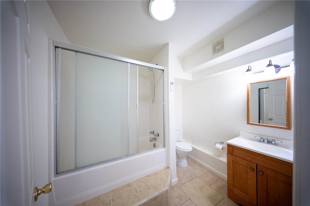 19701 Dovetail Court Tehachapi, CA 93561 - Photo 25 of 44 a bathroom with a granite countertop sink toilet and shower