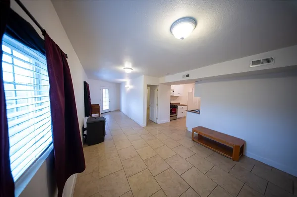 a view of a room with a ceiling fan