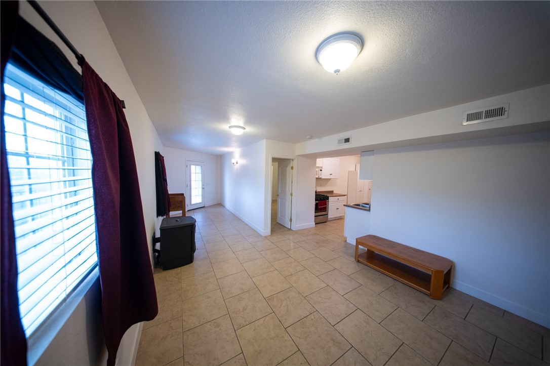 19701 Dovetail Court Tehachapi, CA 93561 - Photo 27 of 44 a living room with furniture and a flat screen tv