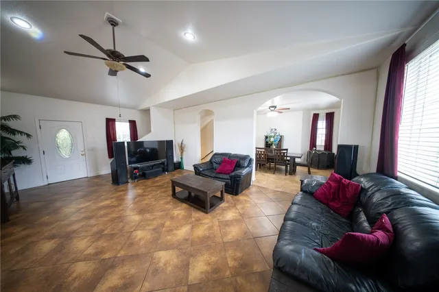 a living room with furniture and kitchen view